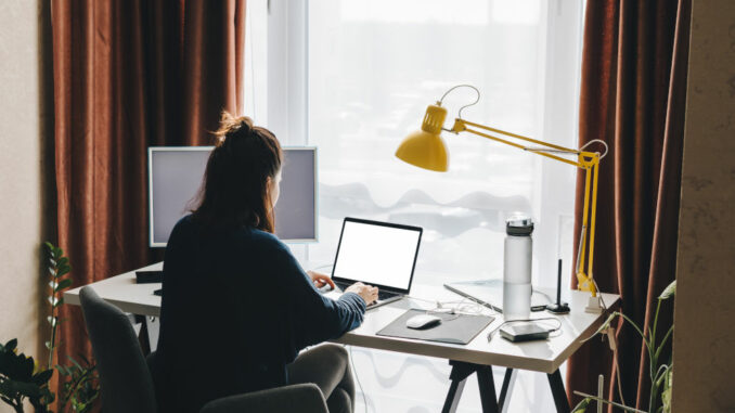 woman working on laptop at home. telework